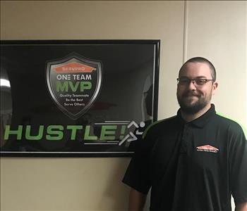 Dan standing in front of a SERVPRO plaque in our office hallway