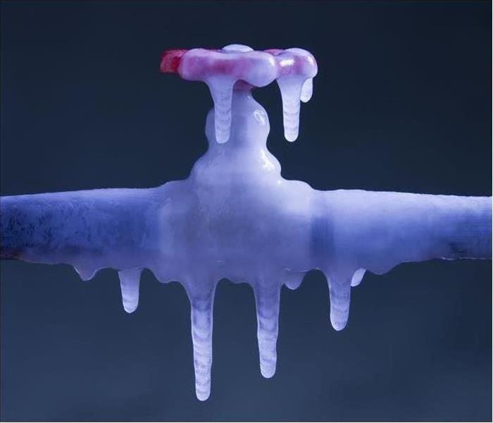 A image of a pipe with a valve that is frozen over due to the cold
