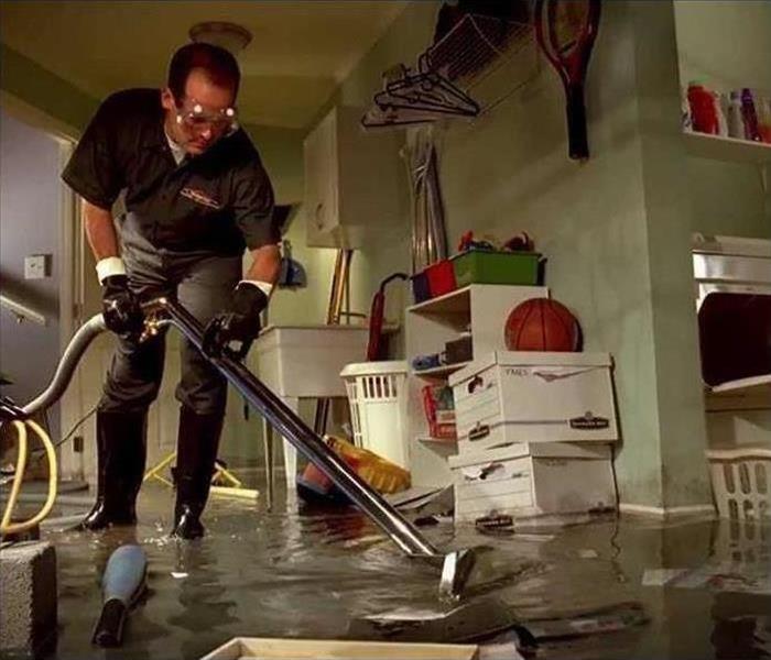 SERVPRO Ad cleaning a flooded basement with floating objects all over